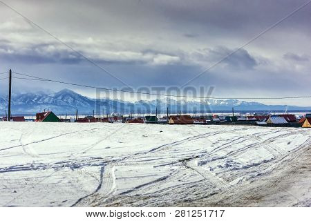 Winter Village View. Snow Covered Mountains. Moubtains, Buildings