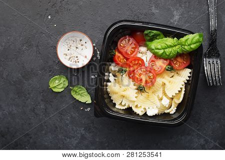 Meal Prep. Delicious Homemade Dinner Pasta Bows, Cherry Tomatoes, Granulated Curd, Basil In Black Pl
