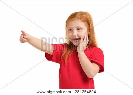 Education, School And Imaginary Screen Concept - Cute Little Girl Pointing In The Air Or Imaginary S