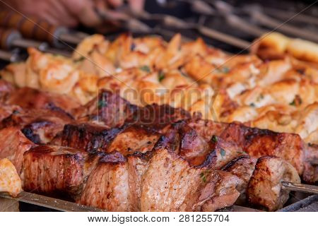 Grilled Shish Kebab From Pork Meat And On The Back Of The Grill From Chicken Meat