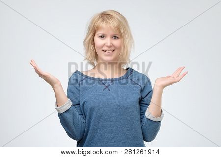 Joyful Excited Blonde Woman Dressed In Blue Pulover, Is Shocked