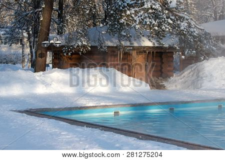 Warm Swimming Pool With Blue Water And Wooden Russian Bath In Sunny Winter Weather, Outdoor.