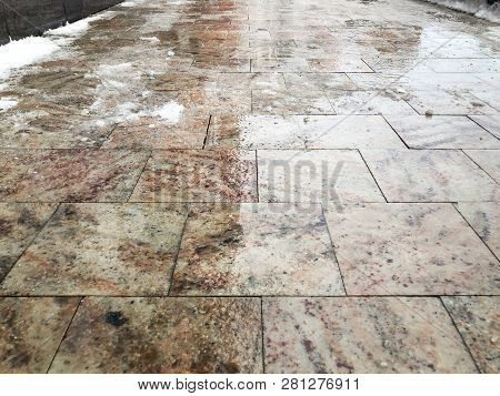 De-icing Chemicals On The Winter Road. Pavement Is Sprinkled With Technical Salt Or Salt Mixtures Ba