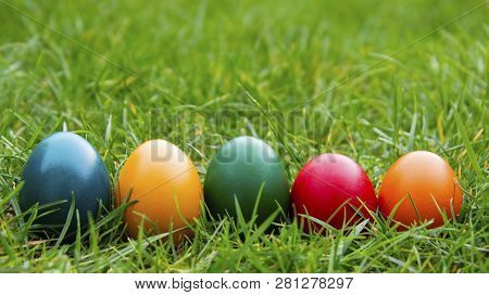 Easter Colorful Eggs In Fresh Green Grass. - Yellow, Green, Red, Orange And Blue Eggs. Spring, Easte