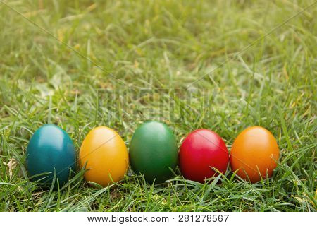 Easter Colorful Eggs In Fresh Green Grass. - Yellow, Green, Red, Orange And Blue Eggs. Spring, Easte