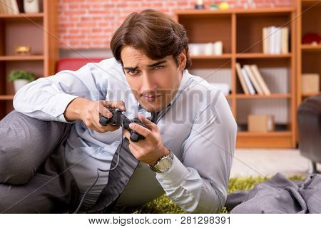 Young employee playing joystick games during his break 