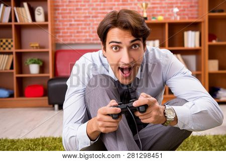 Young employee playing joystick games during his break 