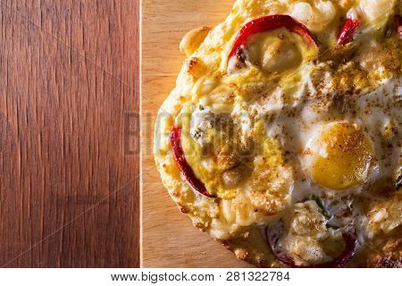 Baked Egg With Cheese And Vegetables On Bread On A Wooden Board. Copy Space