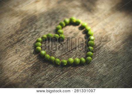 Heart Shaped Peas Green Colors, Wooden Background Grey Colors