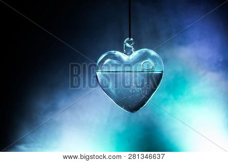 Valentines Day Concept. Glass Transparent Heart On Dark. Crystal Heart In The Dark, Glass Heart Glow