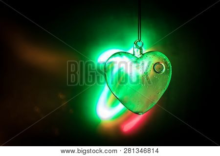 Valentines Day Concept. Glass Transparent Heart On Dark. Crystal Heart In The Dark, Glass Heart Glow
