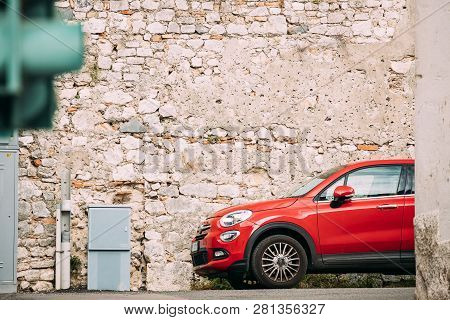 Terracina, Italy - October 15, 2018: Red Color Fiat 500x Car Parked On Background Old Wall.
