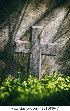 Closeup on a stone cross on a tomb in a cemetery