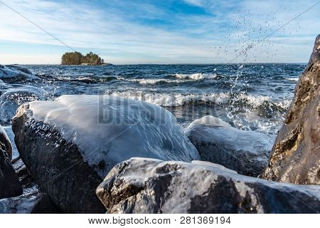 Icy Stones On Beach Near Lake Vattern