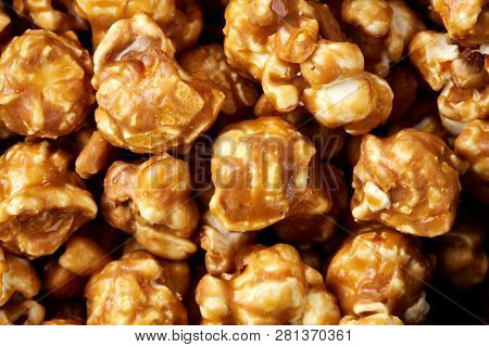 Caramel Pop Corn Background. Golden Caramel Popcorn Close Up. Background Of Popcorn. Snacks And Food