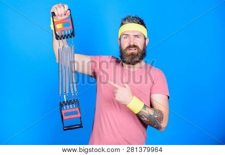 Sportsman Training Stretching Expander. Man Bearded Athlete Exercising With Expander. Guide Use Expa