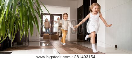 Kids Running Into New House Parents With Boxes On Background