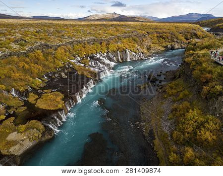 Aerial View Of Autumn Foliage At Hraunfossar Waterfalls In Husafell, West Iceland