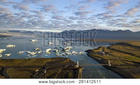 Aerial View Of Icebergs Floating Out To Sea At Jokusarlon Glacial Lagoon, Southeast Iceland.
