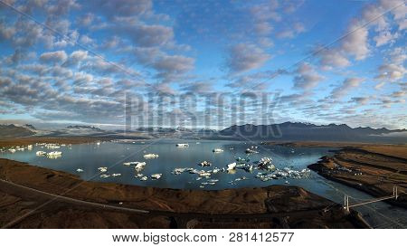 Aerial View Of Icebergs Floating Out To Sea At Jokusarlon Glacial Lagoon, Southeast Iceland.