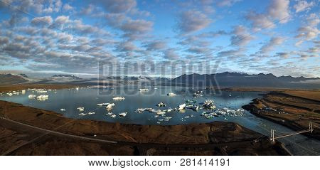 Aerial View Of Icebergs Floating Out To Sea At Jokusarlon Glacial Lagoon, Southeast Iceland.