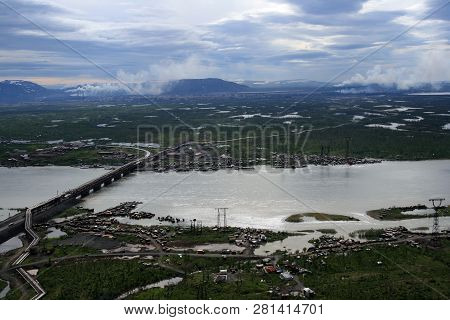 The River, Lakes And Tundra Near Norilsk Metallurgical Plant. The Bridge Over The River And Boat Sta