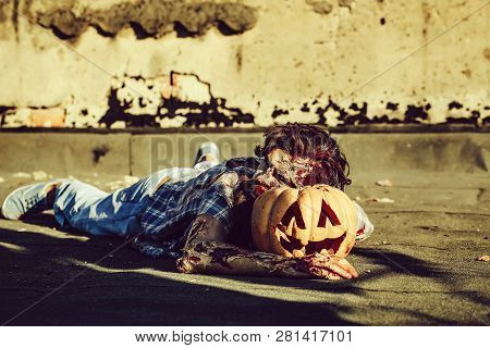 Bearded Zombie Man With Beard Creepy Vampire Or Bloody War Soldier With Wounds And Red Blood Lies On