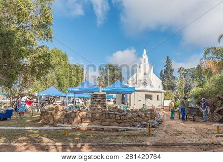 Clanwilliam, South Africa, August 28, 2018: Street Vendor Stalls, People, The Big Trek Monument And 
