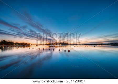 Helsinki, Finland. Landscape With City Pier, Jetty At Winter Sunrise Or Sunset Time.  Tranquil Sea W