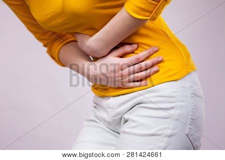 Health Care Concept. Bellyache, Indigestion Or Menstruation. Young Female Suffering From Strong Stom