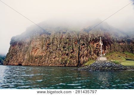 Rocky Sea Coast On Misty Sky In Heimaey, Iceland. Mountain Formation Along Coastline. Sea On Mountai