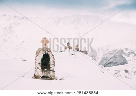 Stepantsminda, Gergeti, Georgia. Cross On Stones On Mountains Background Near Gergeti Trinity Tsmind