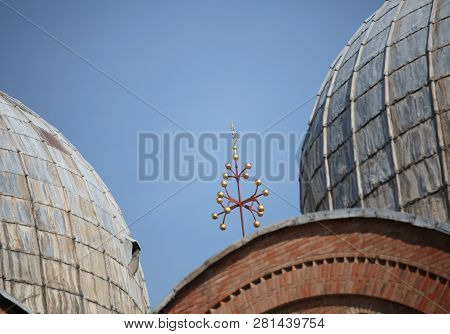 Detail Of The Golden Cross And Big Domes Of Basilica Saint Mark In Venice In Italy