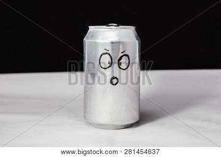 Concept Of Dumbfounded Man. Confused Emoticon On Aluminium 0.25l Can, Emoji With Surprised Face. On 
