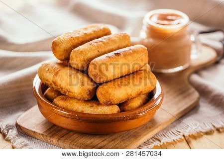 Cheese Fingers, Typical Venezuelan Appetizer Called Tequeños Accompanied With A Pink Sauce On A Wood