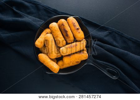Top View Of Cheese Fingers Inside A Black Pan Ready To Eat