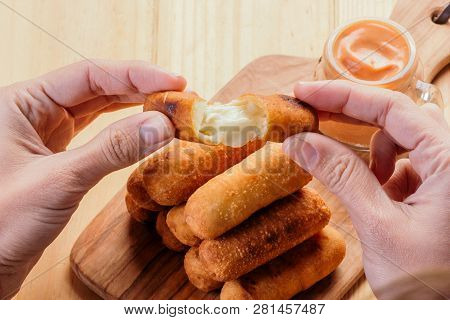 Woman's Hands Holding An Appetizing And Delicious Tequeño Typical Snack Of Venezuelan Food