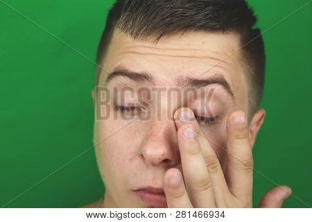 Tears In Eyes Of Crying Adult Man. Green Background. Chromakey