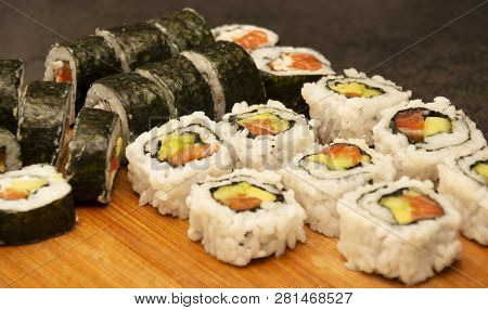 Homemade Sushi Rolls Laid Out On A Wooden Board