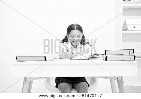 Excellent Pupil. Girl Child Writes Hometask While Sit Table White Background. Schoolgirl Studying Wr
