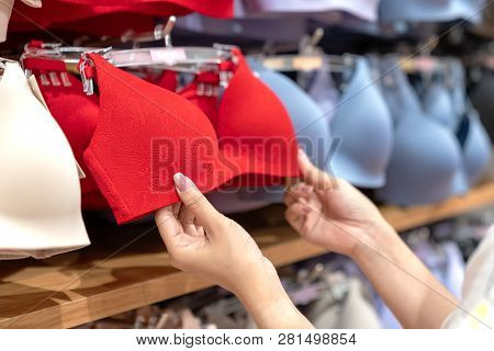 Close Up Of Hands Choosing Bras Cups Size And Looking Light New Wireless And Seamless Technology Wit