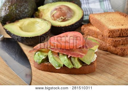 An Avocado Sandwich With Bacon And Tomato On Gluten Fre Toast