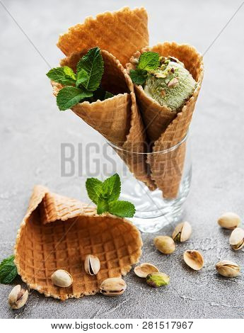 Pistachio Ice Cream And Mint With Pistachio Nuts On A Stonebackground
