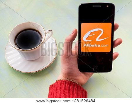 MOSCOW, RUSSIA - JANUARY 02, 2019: Alibaba.com icon displayed on smartphone and a piece of coffee.
