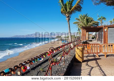 Puerto Del Carmen Beach In Lanzarote, Canary Islands, Spain, Heart Shaped Padlocks, Blue Sea, Palm T