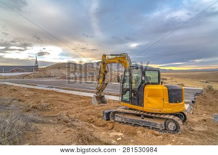 Excavator In Utah Construction Area Near Church