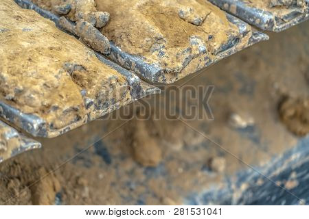 Excavator Metal Track Pad Caked With Dry Dirt