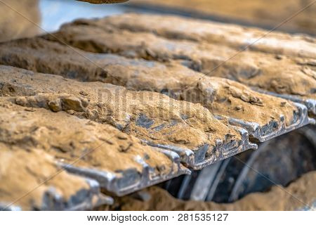Metal Grouser Pad Of An Excavator Caked With Dirt