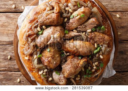 Palestinian Dish Of Chicken With Sumac, Pine Nuts And Onions On A Flat Bread Closeup. Horizontal Top