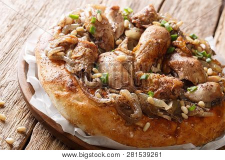 Palestinian Chicken With Sumac And Onions Served With Taboo Bread Close-up On A Plate. Horizontal